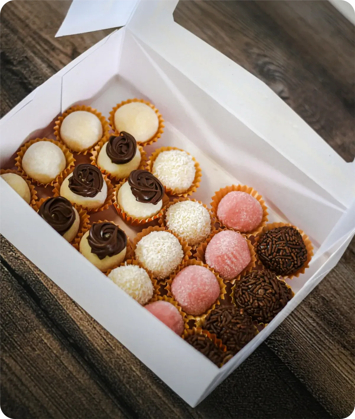 Box of assorted brigadeiros and sweets for a party
